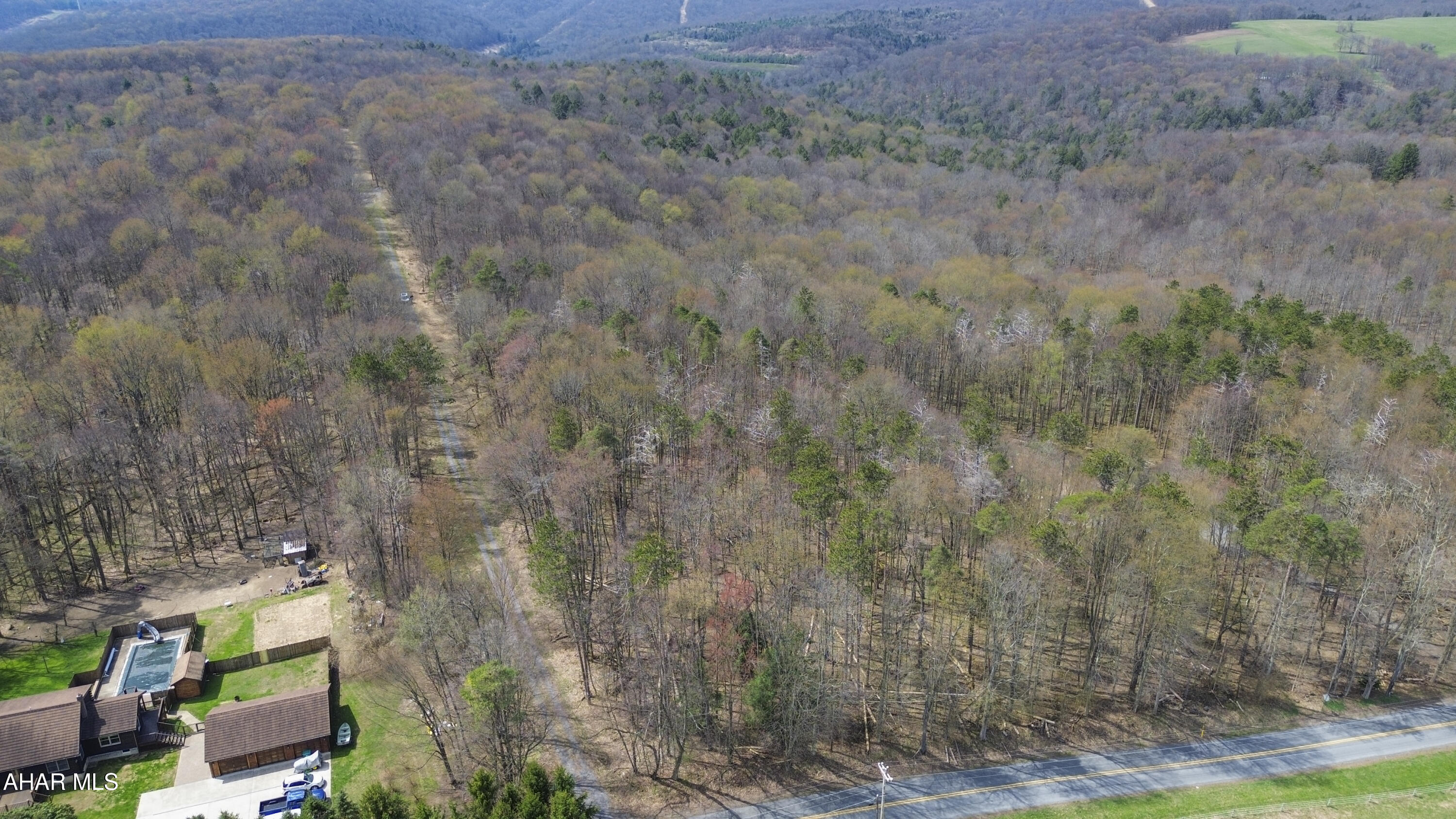 Flat, approximately 1.7-acre parcel located along Benshoff Hill Road in the Central Cambria School District. This property borders the beautiful Gallitzin State Forest, offering privacy, scenic surroundings, and direct access to nature. An excellent opportunity to build your dream home or private retreat while still being conveniently located to nearby amenities. Water is located approximately 250 feet on the other side of the road, natural gas is running right along the front of the property, and electric is nearby - buyer to verify. Call today for more information!