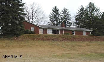 2 or 3 bedroom brick rancher across from Reservoir Park. Stone fireplace in living room.