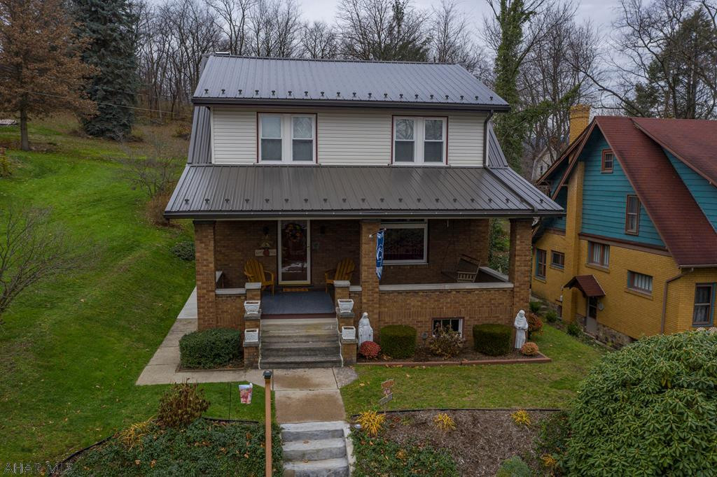 Incredibly well built brick home in a quiet neighborhood tucked away but close to everything. This spacious home offers a large oversized eat in kitchen with a bonus room including a cozy fireplace. Entertaining areas behind and the home is backed up to woods where wildlife can often be spotted. Central air and hot water heat make this a comfortable year round home. Large covered porch for relaxing and even a gas plumbed hookup for grill out back make this a home to sit back and enjoy. Three bedrooms and 1.5 baths with a two sided entry staircase to the 2nd floor. Brand new metal roof last year.