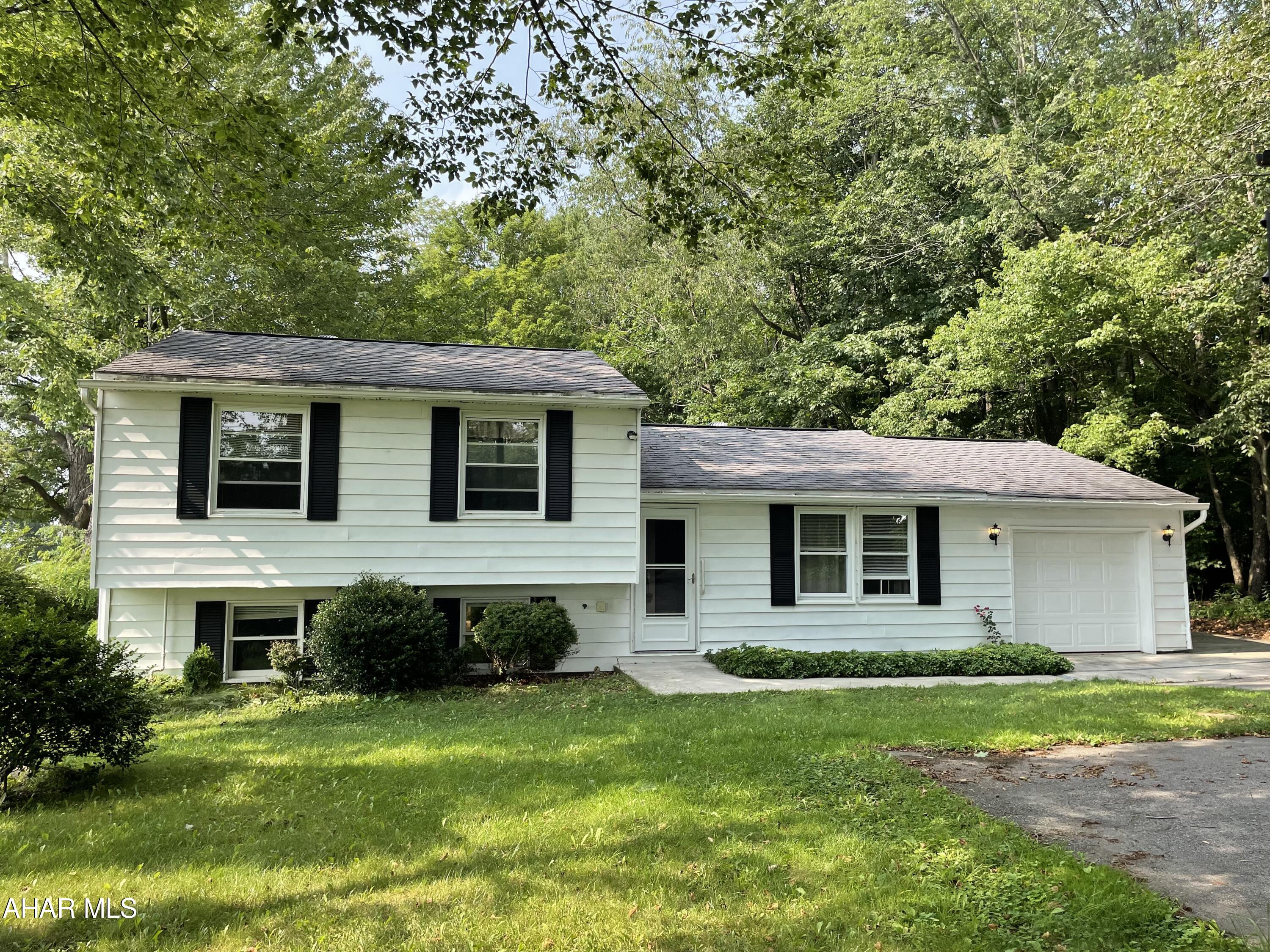 This multilevel home is sitting on a half acre parcel in a quiet area across from Mount Aloysius College, quick access to the main Highway for easy commutes to work. A great home to entertain family and friends as you can see into the spacious living room and dining room from the kitchen.  A great use of space in the kitchen and all appliances are included.  The lower level family room is the perfect to host game nights or watch the football games!  The lower lever has a utility room with laundry hookups and space for storage.  The three bedrooms and baths are all located on the upper level.  The spacious master suite has plenty of closet space and an updated bath with walk in shower.  There is a one care attached garage which is convenient to bring groceries inside and a shed to store your lawn and garden tools.  There is plenty of space to roam around outside  and plenty of room for all your guests to park.  A recent open tank septic test was done by Dave Eckenrode and is in proper working order.  Call to schedule your showing.