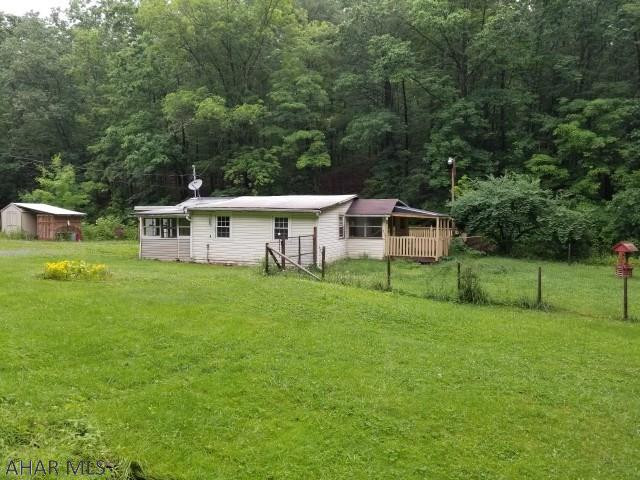 2 bedroom bungalow on 5.15 acres near Vail. Large deck over the stream. Large detached workshop.