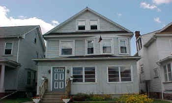 MUST SEE INSIDE! Very nice maple kitchen with cherry finish, large foyer, living room, dining room. Pine floors, new windows and newer furnace & C/A.  Finished attic with heat and C/A. 3 parking spaces in alley.