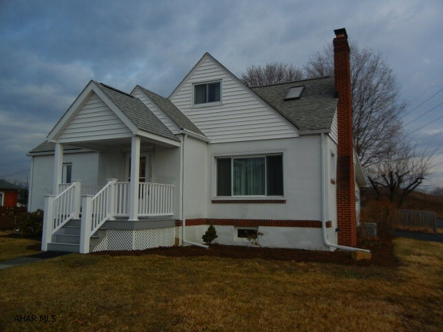Cape Cod on double lot features 4 bedrooms, plus office, new hardwood floors in living/dining areas. New front porch, oversized Florida room at rear used as garage space in winter.  Fenced back yard.