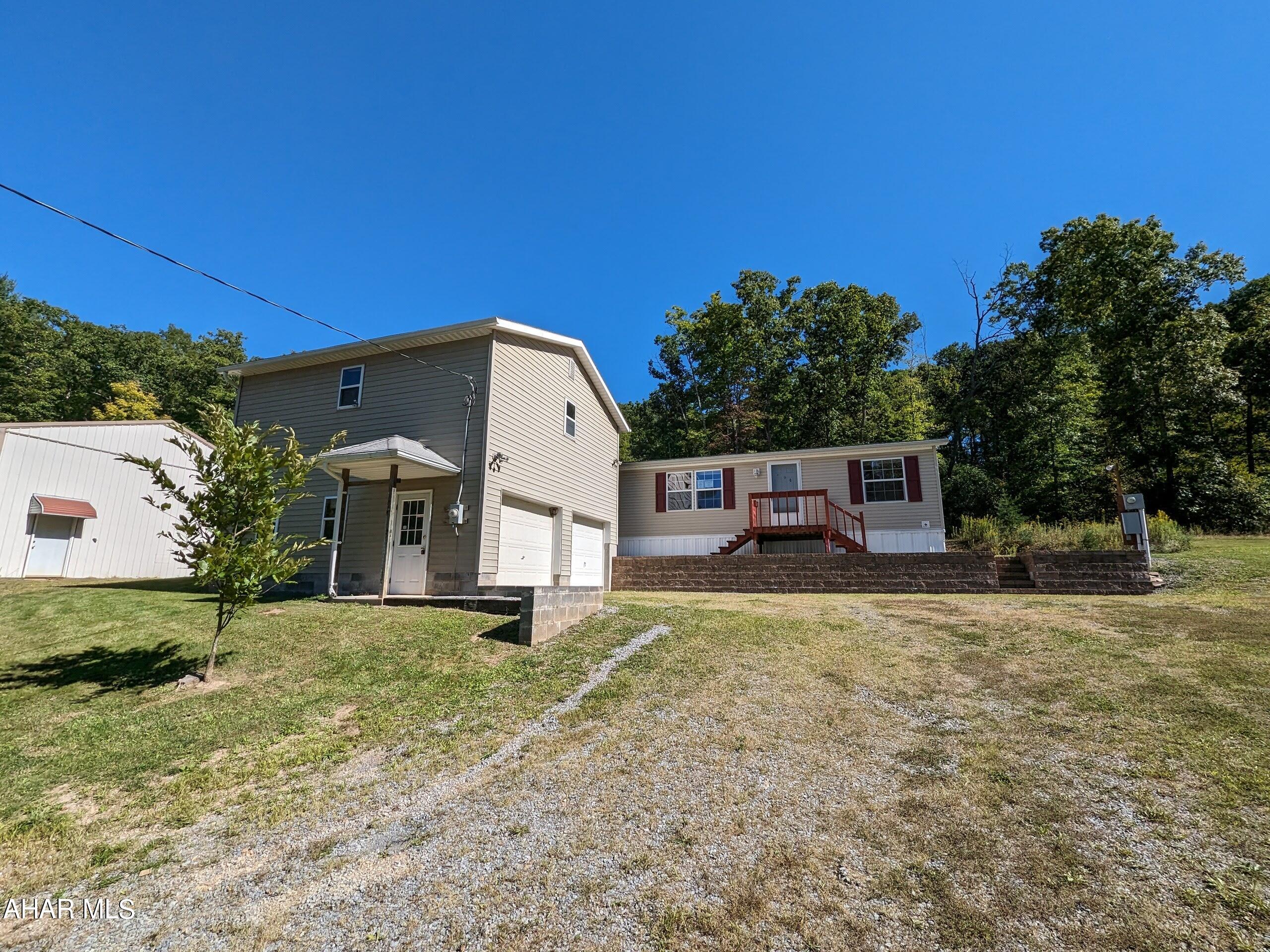 Rare find and unique opportunity for this 10 acre Clearville property which includes double-wide home, 2 car detached garage w/ 2nd floor loft/workshop, large pole building w/ loft plus storage trailer. Privacy and open space can be yours. Property sold AS-IS. Seller will make no repairs. Offers must be submitted through HUD approved broker. Buyer pays both transfer taxes. Exclusive Agency. Equal Housing Opportunity. www.HUDHomestore.com. Type and functionality of on-lot sewage system is unknown.