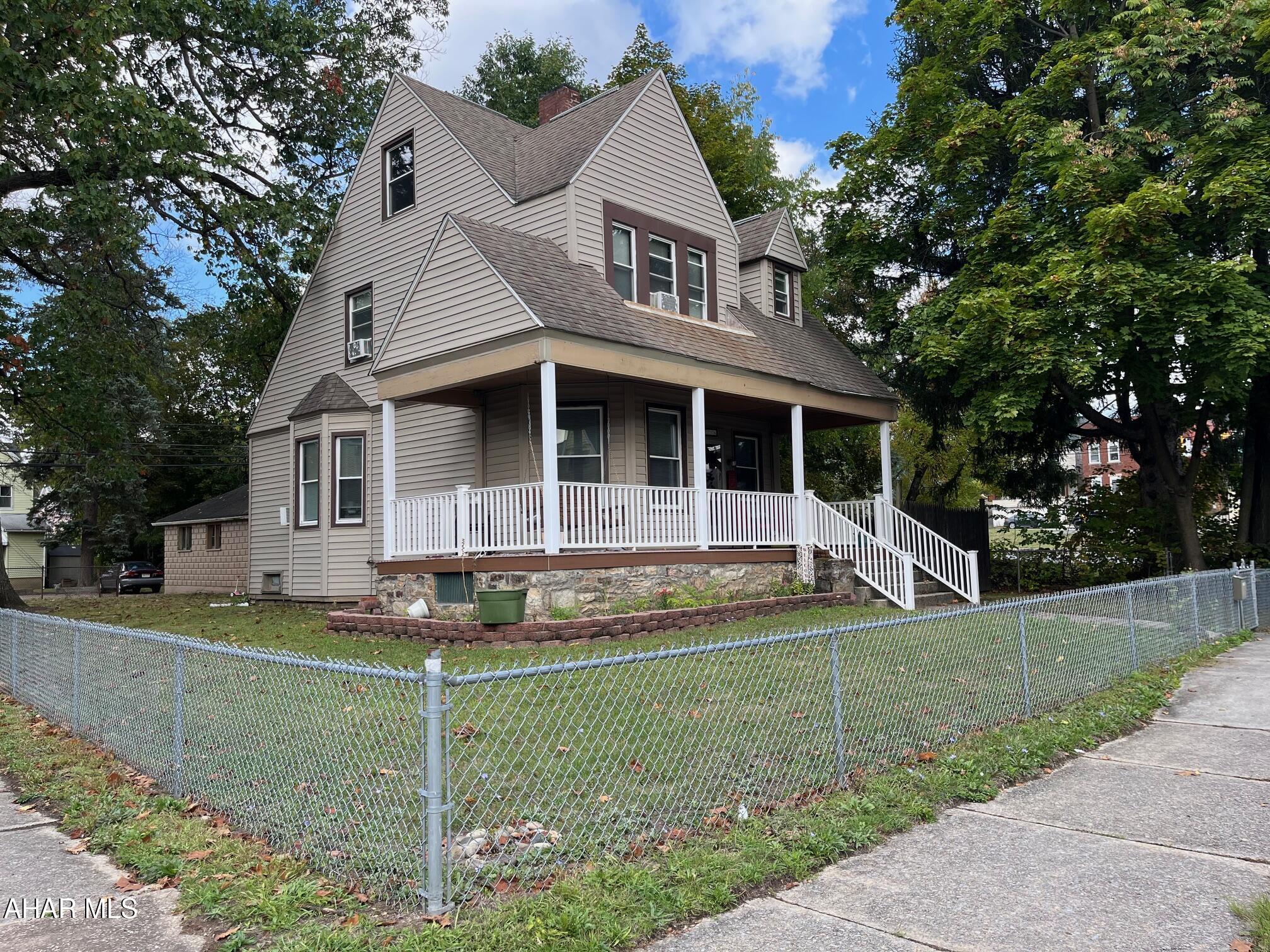 Charming 2 1/2 Story home on a nice corner lot.  House is in good condition.  Updated bathroom.  Beautiful hardwood floors. A very unique property in the city.  A two-car garage in the rear of property. Wood Fireplace in Living Room and Electric Fireplace in main Bedroom.  Fenced yard A must see.. Attic unfinished with heat. All windows have been replaced. Gas hot water heat.