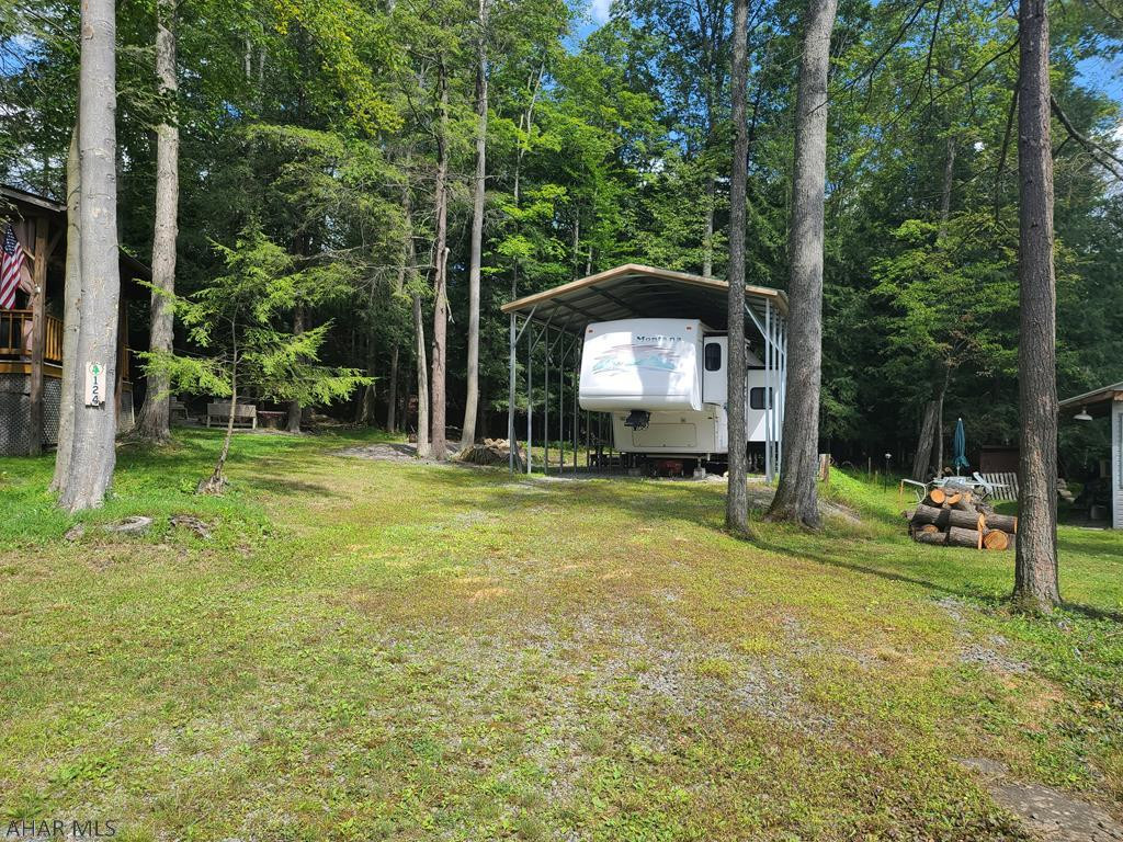 30' 5th wheel 2002 camper under a metal frame pavillion on 1 lot inside Glendale Yearound. Camper is very roomy and in great condition. There is a washing machine included. Glendale Yearound is a gated community located minutes from Glendale Lake and Prince Gallitzin State Park. Community pool, basketball, tennis, security, and more.