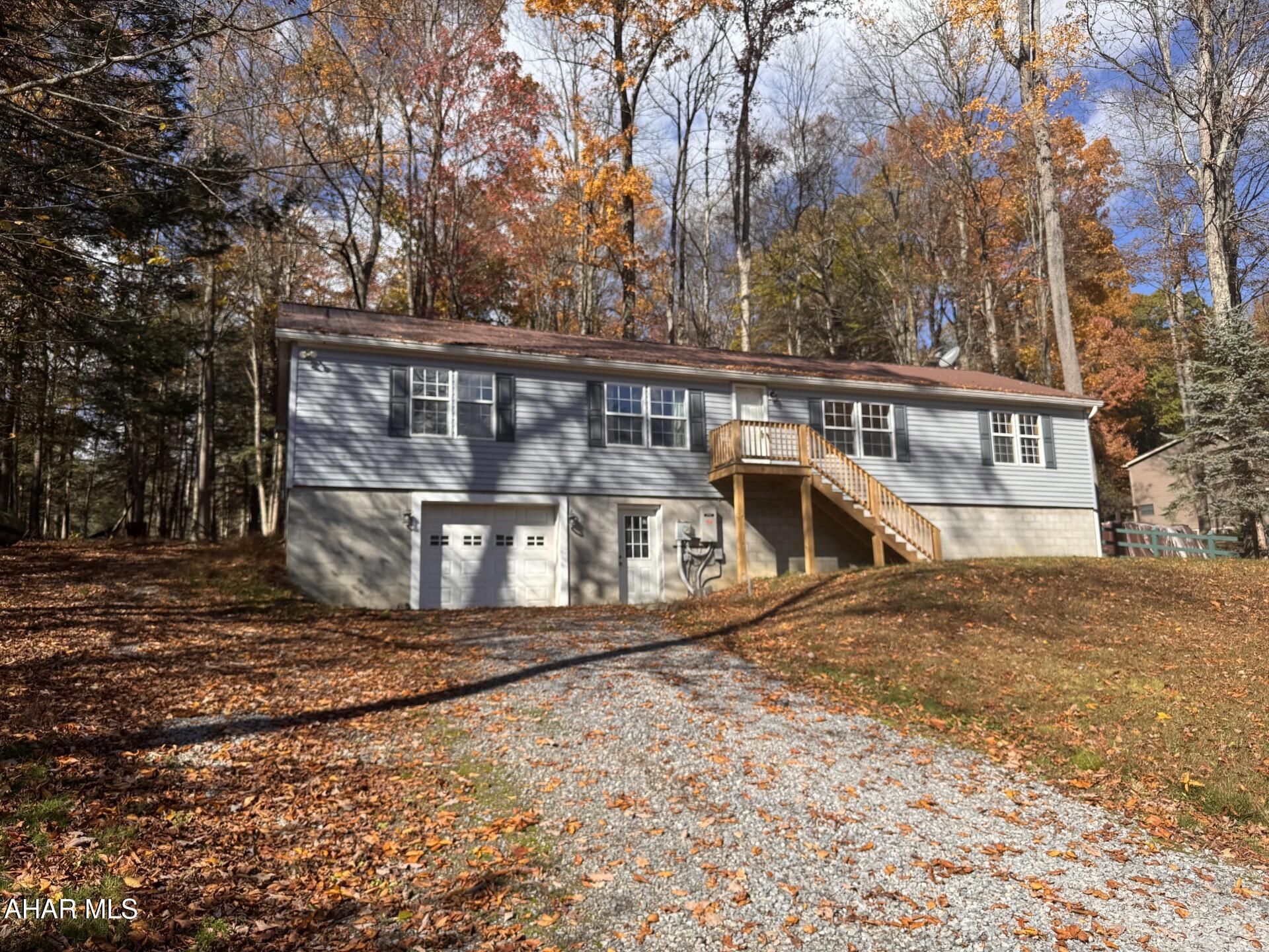 Spacious 3 bedroom , 2 bath modular home with new siding & gutters on a 1 acre lot.   Large Eat-in Kitchen, LR w/wood fireplace.  Propane, forced air w/ central air.   Large screened-in rear porch for relaxing in the summer or holding outside dinners.  Totally finished basement with coal stove as additional heat.  1 Car Integral Garage. Move-in condition!