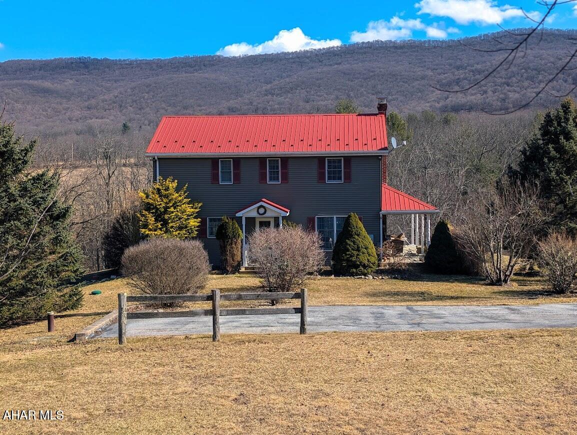 There is so much to enjoy with this country home situated on 12.7 acres nestled among the mountains. This one checks all the boxes for enjoying life off the beaten path with lots of unique touches from the past such as old fashioned wood doors and a cozy clawfoot tub on the second floor. The primary bedroom has an ensuite full bath and walk-in closet. Sip your morning coffee in the open concept kitchen or while relaxing in the spacious living room in front of your fireplace. Read a book on the front wraparound porch or take a stroll out back in the open field. The walkout basement has a gorgeous propane woodstove and ample space for a rec room or additional living space along with a large storage area and utility room with loads of shelving and an oversized freezer. The large detached pole building/garage/barn combination is perfect for storing your vehicles and equipment or maybe farm animals. Located minutes from White Sulfur Springs Retreat and Shawnee State Park. This truly is a home you won't want to miss. Call for your tour.