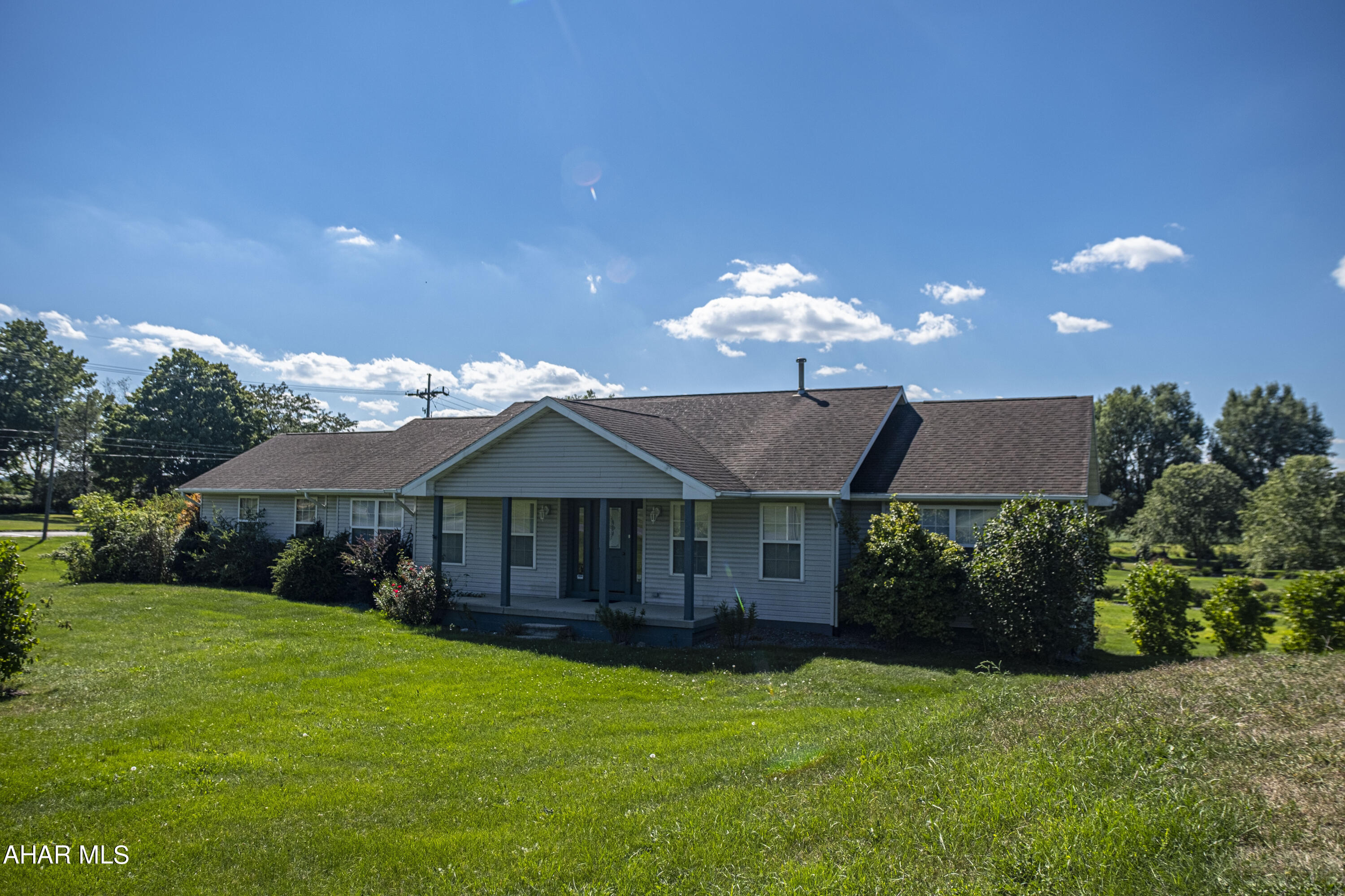 So Much to offer!  Rural Martinsburg one-level living on over 1-1/3 acres! ...Country living, but just a few minutes from services, shopping & restaurants in town.  Cooking enthusiasts will love the kitchen with all new Bosch appliances and an island + table space. Large family room off the foyer is great for entertaining or relaxing by the natural gas free-standing fireplace. Large MBR has jacuzzi-style tub and step-in separate shower. Step-up 4th bedroom can be office or apartment, with kitchen and bath.  Expansive deck off family room (new Pella sliding glass door) with steps down to the driveway and back yard.  Short walk or drive to Ritchey's Dairy Store/Ice Cream Shop.  Also, only a couple of miles drive to the Blair County Airport.  The unfinished basement has 4 rooms, and access to the oversized 2-car garage.