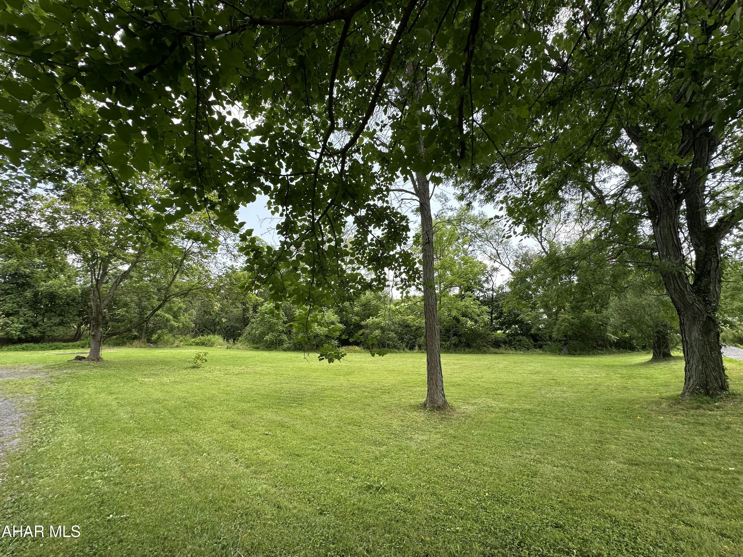 This home has a spacious walk-out deck that provides the ultimate outdoor retreat.  Enjoy the private backyard framed by mature large trees.  There are some key features you'll love including refinished hardwood floors, freshly painted walls throughout, and a brand new kitchen and roof.
