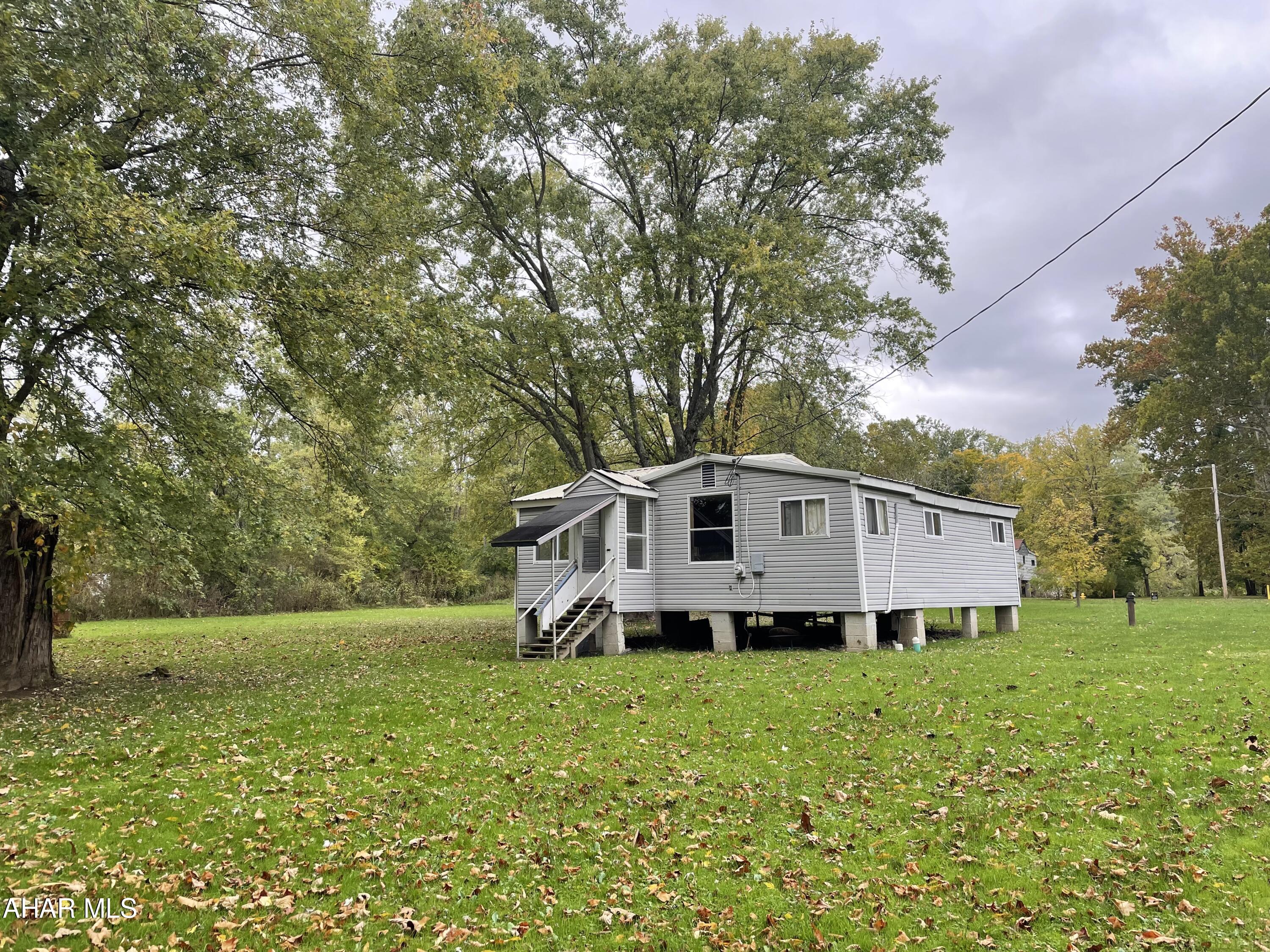 This multi lot listing provides endless possibilities. This could be an opportunity if you are looking for a relaxing escape to a private oasis. Imagine a weekend of fishing in the early spring, summer cookouts and picnics taking you into warm bonfires into the fall. There is so much charm, and opportunity on this unique piece of property that you won't want to miss it if you're looking for that perfect little hideaway. Includes the current structure that could be finished or replaced. Public water and sewer are on this lot.
