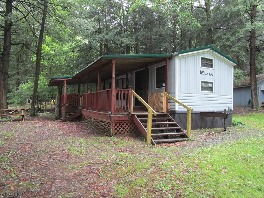 Nicely maintained and updated park model camper on approx. 1/4 acre of land ( 3 campsites).  Two bedrooms; one with a double bed and the other with double bunks.  New touches made by the sellers.  Tucked into the woods with a large shed for your tools and toys.  Lots of memories and meals will be made around the great fire pit area!  So much room and privacy for your family to get away into nature.  Glendale Yearound offers a community pool, playgrounds, tennis/basketball/volleyball courts, dog park, club house and activities.  Adjacent to Prince Gallitzin State Park / Glendale Lake.  Six miles from Rock Run ATV Park.  Come and see what you are missing!