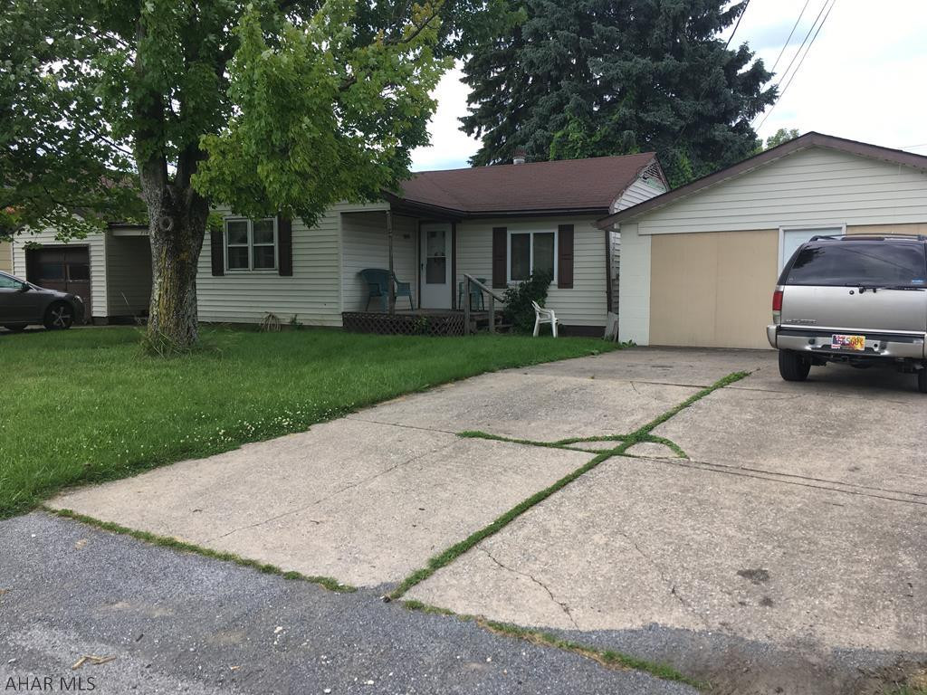 Ranch home with a detached one car garage and a 6 car garage currently used as an apartment. Great investment home with some TLC.