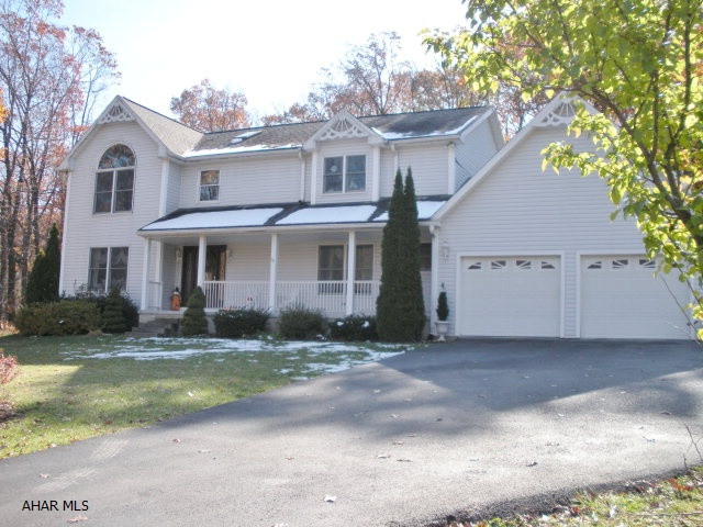 Beautiful 4/5 Bedrooms, 3.5 Baths, home on 4 private acres.  2 family rooms, cherry kitchen with island, 1st floor laundry, master suite with walk-in closets and vaulted ceiling.  Finished lower level with tons of storage, 2 car garage.  Dining room with hardwood floors.  Formal Living Room, Gas fireplace and central air.  In-ground pool with pool house.