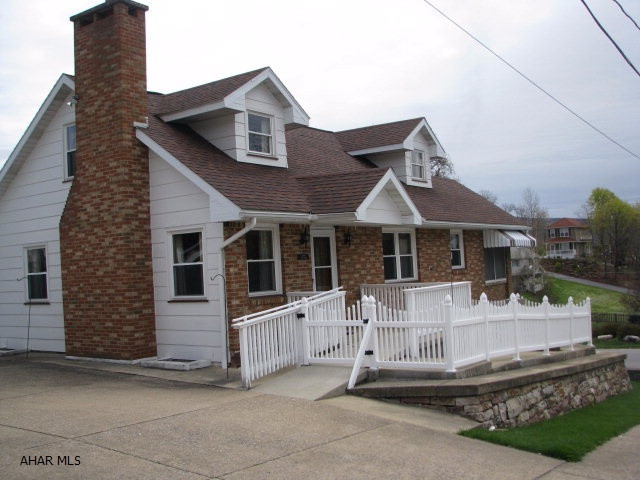 Spacious Cape Cod on corner lot in a quiet neighborhood.The 1st floor's open floor plan gives you plenty of space for whatever your needs may be.  Whether it be entertaining or just relaxing by the fireplace.Laundry on the 1st floor is an added bonus that many of us would love to have. Off the eat in kitchen is a porch which runs the entire length of the home.From this vantage point you will have beautiful views of the mountains.The second floor has two large bedrooms and a full bath.If after all this you still are looking for more room you will find it in the lower level. The family room is finished and a large utility room with a partial bath.An integral one car garage along with a detached brick two car garage rounds out all this home has to offer. 3 zoned baseboard heat for efficiency.