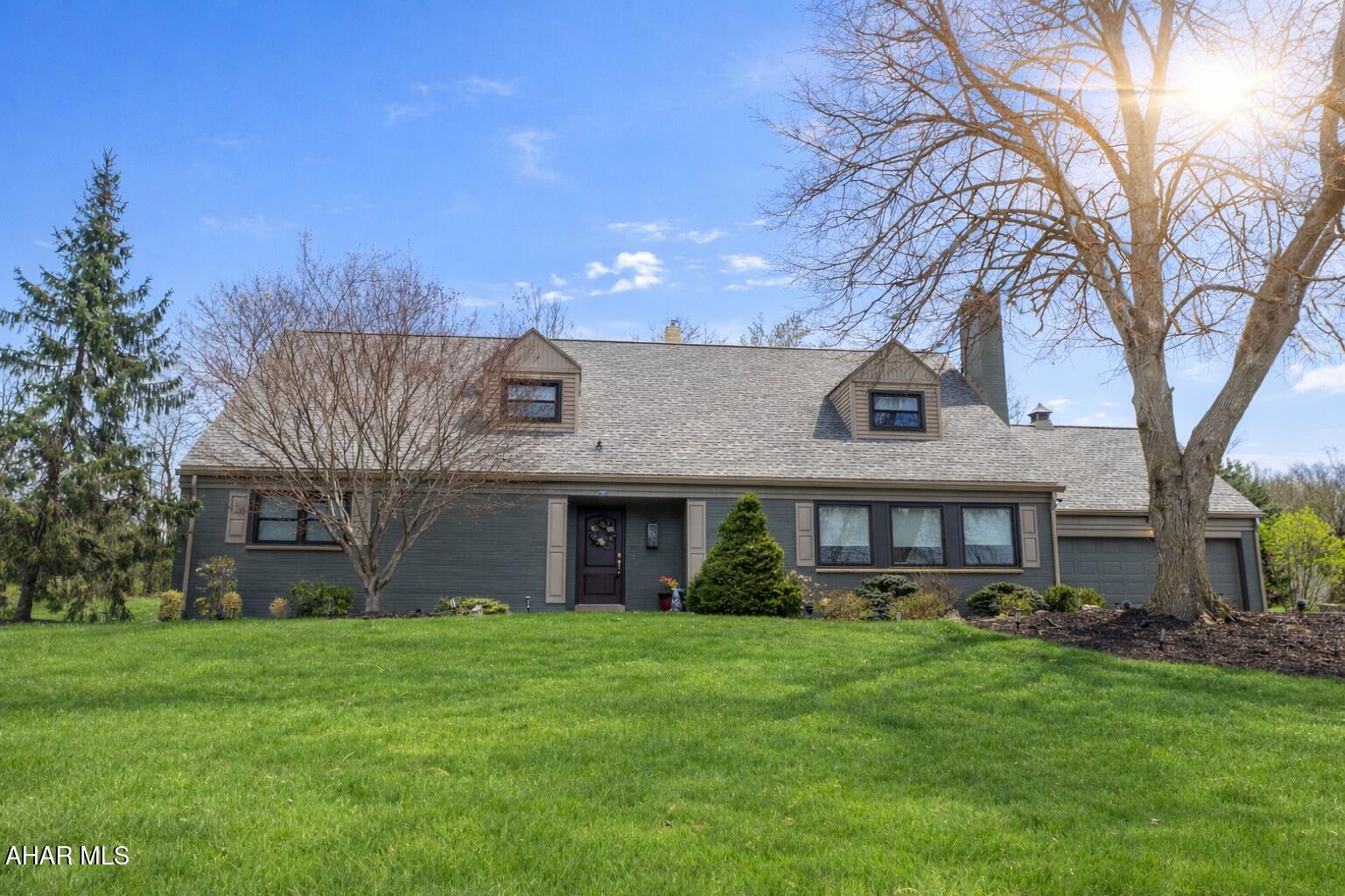 Nestled on approximately one acre at the prestigious corner of Blairmont Terrace and Sylvan Drive, this beautifully updated and impeccably maintained brick home offers timeless character in one of Hollidaysburg's most sought-after locations, directly across from the Sylvan Hills Golf Course.

Rich in character and classic charm, this exceptional residence blends timeless craftsmanship with thoughtful modern updates. From the moment you step inside, you're welcomed by rich dark-stained hardwood floors flowing throughout the main level and into the expansive living room, centered around a stunning wood-burning fireplace and beautiful built-in cabinetry that adds warmth and sophistication.

Featuring 4 spacious bedrooms, (including a generously sized main-floor bedroom) 3.5 bathrooms, and a versatile bonus room perfect for a home office, nursery, or potential 5th bedroom, this home offers both elegance and flexibility for today's lifestyle. 

The beautifully updated kitchen is truly a showpiece, featuring tasteful finishes, under-cabinet lighting, ample outlets, a second oven and exceptional storage throughout. Just off the kitchen, an elegant butler's pantry and beverage center with a built-in wine refrigerator creates the perfect space for entertaining.

Upstairs, the spacious primary suite serves as a private retreat, complete with a beautiful built-in wall dresser, abundant closet space, and an en-suite bath featuring a jacuzzi tub and separate stand-up shower. 

Storage in this home is simply unmatched, with endless space thoughtfully integrated across every level.

The lower level offers incredible potential with new flooring throughout, a half bath, and expansive space that can easily be finished for additional living, recreation, or entertaining space.

Step outside to your own private oasis featuring a large screened-in back patio, a stunning in-ground saltwater pool, and a 2nd uncovered patio perfect for relaxing or entertaining.

With its stately brick exterior, timeless character, custom built-ins, exceptional updates, and premier location, this is a rare opportunity to own an extraordinary home.