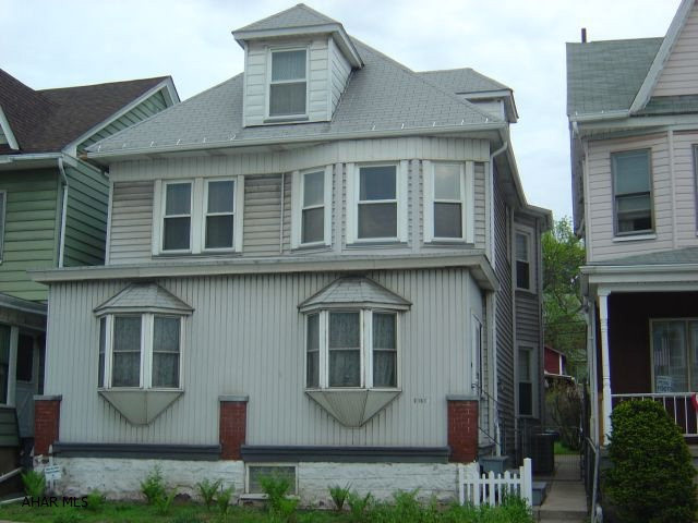 4/5 Bedroom, 3 bathrooms, living room with fireplace. Garage and carport, newer roof, furnace, windows, electric, 1st floor laundry, hardwood floors, could possibly be a duplex, excellent condition, beautiful woodwork.