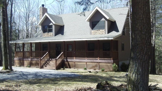 This home is a gem and must be seen to appreciate it.  Sitting on a private, wooded lot in Glendale Yearound a covered deck wraps around 3 sides of the home.  Enter in the front door to a gorgeous great room with cathedral ceiling and stone fireplace.  The eat-in kitchen includes a Kitchen Aid electric range and refrigerator, both stainless steel.  A deep, soaking tub is in the 1st floor master suite.  Two additional bedrooms are on the second floor along with a full bath and a sitting area at the top of the stairs that overlooks the great room.  French doors are featured in the walk-out finished basement family room where you can warm up with your wood stove.  A 3/4 bath, bonus and utility room finish out the basement.  Gated community is adjacent to Glendale Lake. Home warranty included