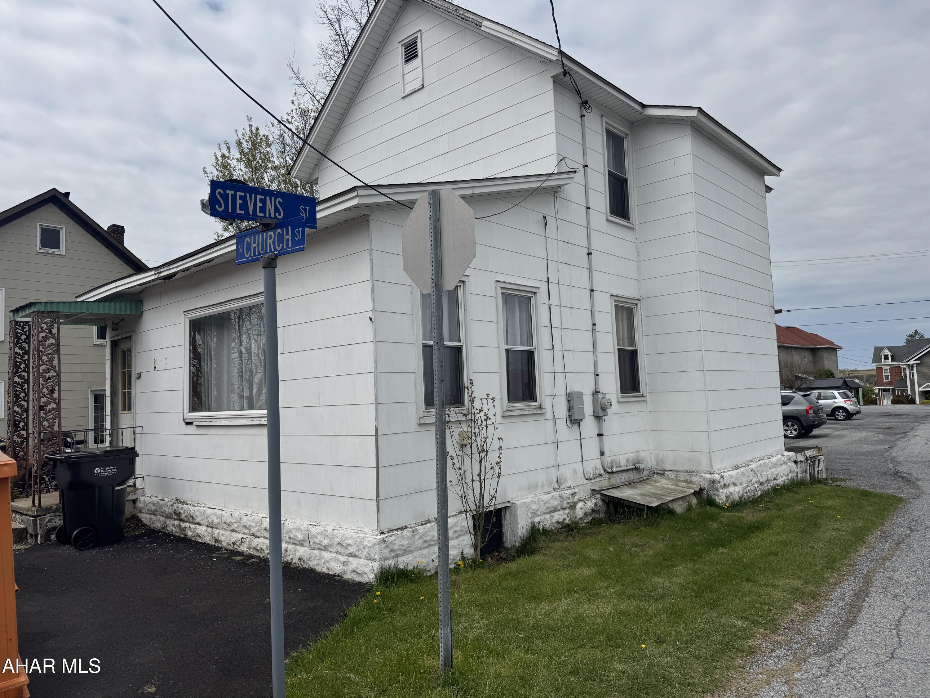 Asbestos sided two story home featuring 2 bedrooms, one bath, kitchen, dining and living room. Full unfinished basement with oil hw heat. The lot is small and is about what the house sits on.  Needs some tlc.