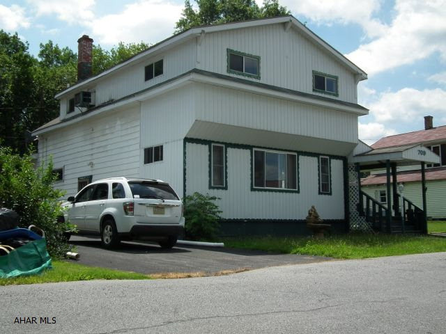 Large 4 Bedroom home with 100x120 (.275 ac) lot above ground pool (last opened 2013). Will need work but great potential! Off street parking in driveway + additional paved area on side.