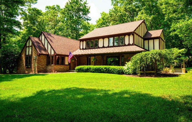 SELLER SAYS BRING ME AN OFFER!  This gorgeous 4Br/3+BA home has a meticulously remodeled EIK offering stunning views of the great room with cathedral ceiling and beautiful stone FP.  Spacious rooms, hand shaven hardwood floors, quartz countertops and wrap around deck are some of the eye pleasing features you won't want to pass up.  3 zone heat, 2 zone A/C, newer roof, central vac, and main level laundry are only some of the solid mechanics any buyer would love. LL is a perfect mother-in-law suite or FR with a full BA/workout room and ample storage in the walk up attic or downstairs. Sellers offering 1 year home warranty with acceptable offer.  Schedule your showing today!!