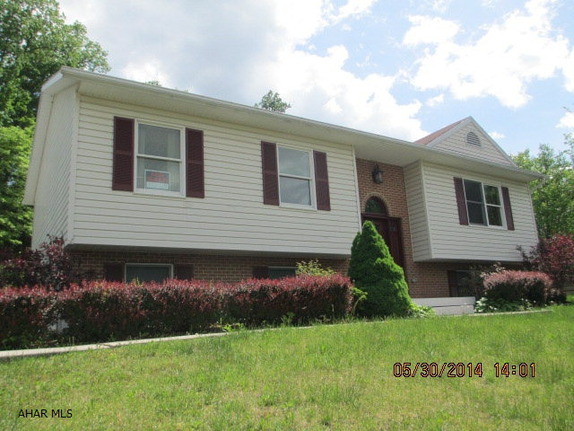 Beautiful Bi-level with Vaulted Ceilings, Skylights.  House in Move-in condition. 3 Bedroom 3 baths.  Family room in basement. Large 2 car garage. Nice private covered deck.  Woods behind property. Kitchen has island.Well Water. Sewer $53.00 month. Electric $159.00 Equalized payment.