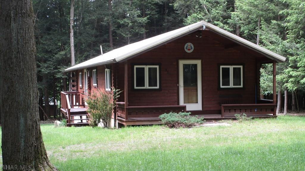 Log cabin with the amenities you enjoy. One bedroom one bath cabin with large living room / modern kitchen.  Love the idea of a log cabin but don't want to rough it?  This cabin offer wall furnace / air conditioning units, new kitchen in 2017 (floor, cabinets, countertop), full bath, 12' x 20' back covered deck for privacy.  Make this your go to place!  Located in Glendale Yearound, a gated recreational community adjacent to Prince Gallitzin State Park / Glendale Lake.  Six miles from Rock Run ATV Park.