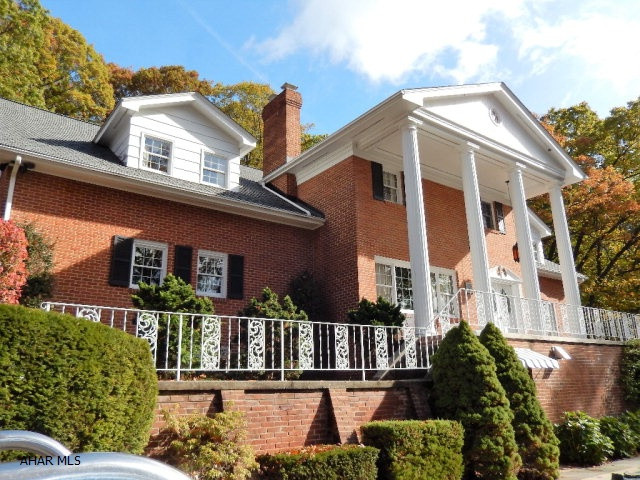 Curb appeal that you cannot miss. This Beautiful brick home is on a secluded 1.5 acres. The Large marble foyer leads to an impressive living room w/fireplace and large formal dining room or family room w/ stone fire place or go up the spiral staircase to another impressive 2nd floor foyer that leads to 5 bedrooms an a den. The eat-in kitchen has many cabinets, ceramic tile floors and large bay window. Full finished basement includes large family room with fireplace, beautiful full bar, Bathroom and laundry room.  Taxes are lower for 2017!