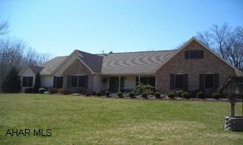 Long list of amenities in this one owner custom built home on 11.62 acres! Four-five bedrooms, 2.5 baths, spacious and open floor plan! Solid oak kitchen has built-in ovens, desk, shelves, ceramic flooring, plus a snack bar! Exit to the patio or to the huge Great Room w/ a vaulted ceiling, berber, built-in shelving and a woodburning fireplace! Master suite is just amazing w/ a vaulted ceiling, lg walk-in closet, whirlpool tub, shower and ceramic tile. Basement is plumbed for bath and has a wood burner and fruit cellar. All oak doors and woodwork throughout, central vac, wood windows w/ lifetime warranty, artesian well.  A welcoming home and setting, great setback line, very peaceful-NO turnpike noise!  Call Tina at 814-242-2047.