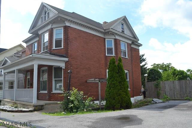 Tasteful two-story offering plenty of space & original charm!   Enter through the large foyer into the living room with character showing in the original woodwork of the stairs & fireplace.  You don't see this type of woodwork detail often.  Large dining room, updated kitchen, laundry(high efficiency washer & dryer stay) and bathroom area complete first floor.  Second story has 3 BRs (one has walk-in closet), an updated bath with dual sinks, clawfoot tub & standup shower, as well as sm bonus area with two closets.  The attic space is walk-up & great for storage or could be finished.  Outside has large fenced in backyard and deck off kitchen.  One of the best outside features?  TONS of offstreet parking in the included extra lot-up to 5 cars.  Could be great starter or rental.  Call today!