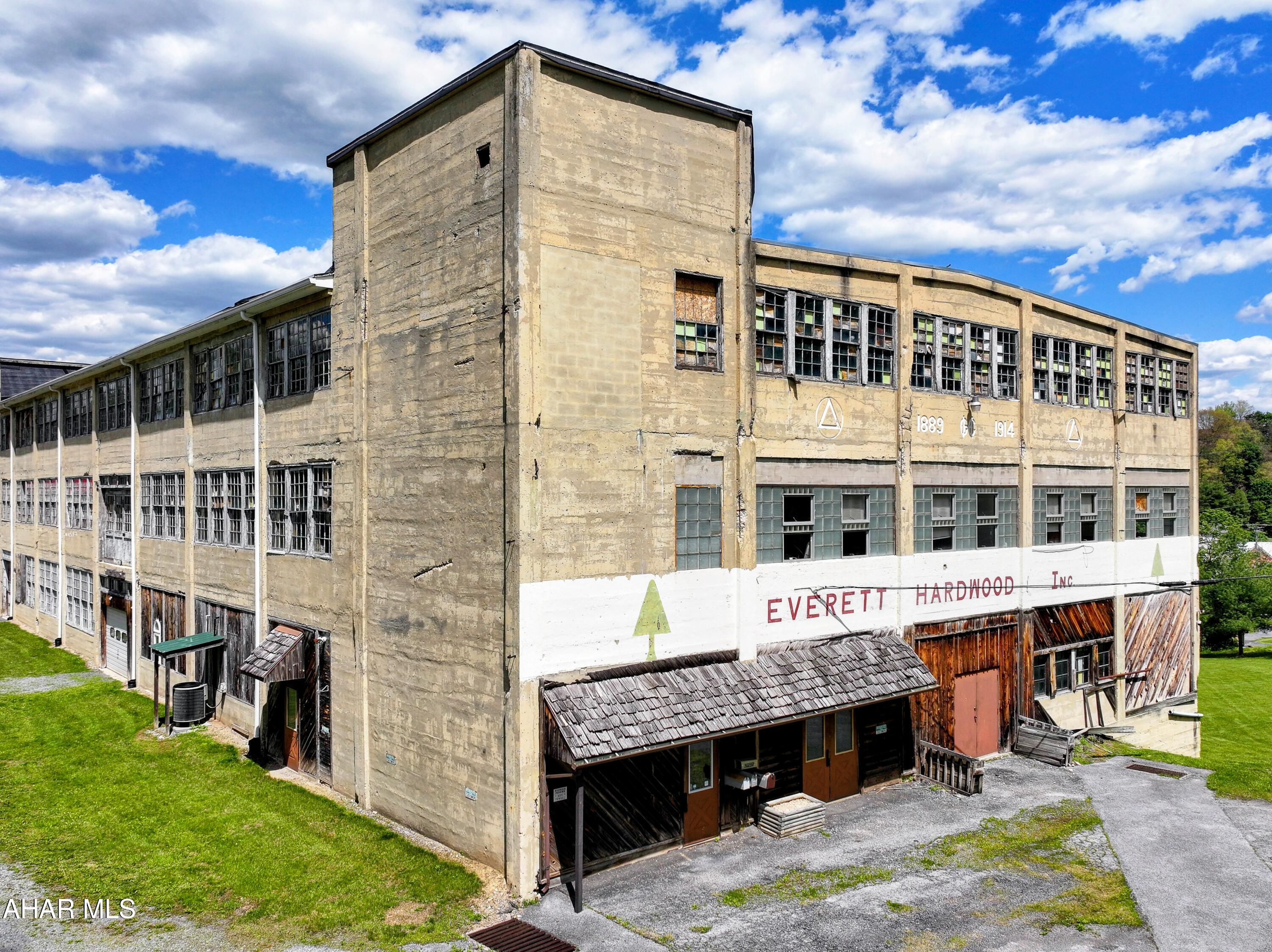 As part of Reimagine Everett, this is a perfect building to purchase to help revitalize the 'Little Town That Can.' Built in the 1900's, this is truly a part of Everett's history. Property consists of 2.9 acres that could have many uses. Building is constructed of concrete with a rubber roof, 4 floors, floor 1-3 have 11 ft ceilings, 4th floor has over 20 ft ceiling.  Elevator in the building and 3 phase electrical. Seller will include all market studies, plans and storm water management papers. Office area did have heat pumps with central air. Seller is not sure of their current condition. Make an appointment to take a tour.