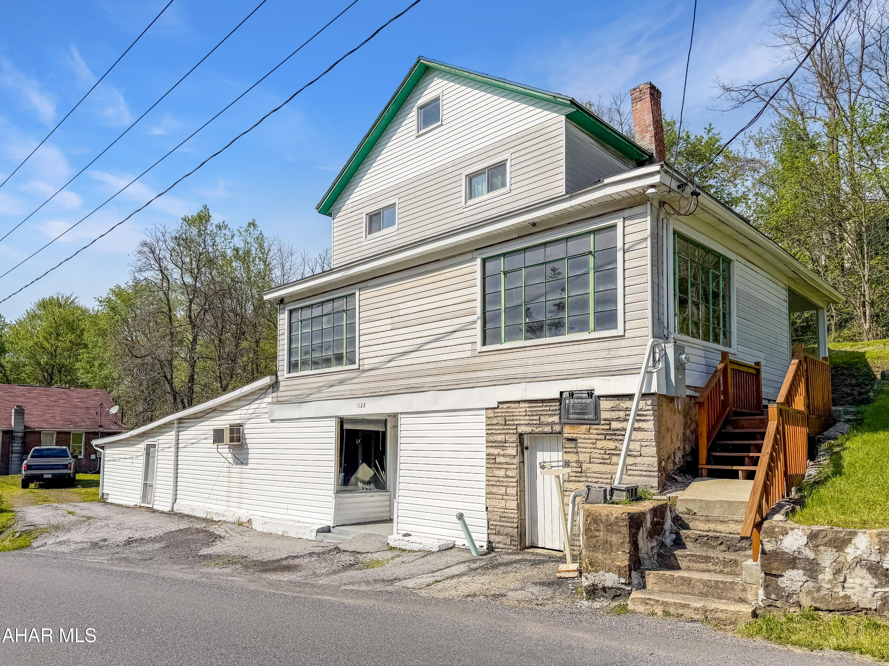 Welcome to 1122 Deveaux Street in Bakerton! Formerly known as Weber's Grocery Store, this unique property has recently been converted back into a single-family home while still offering endless potential for a variety of future uses. The lower level features a large storage area with durable epoxy floors, a walk-in cooler, and houses the mechanicals. The main living level offers a spacious living room, dining room, kitchen with laundry area, bonus room, and a large sunporch filled with natural light. The upper floor features 3 spacious bedrooms and a full bathroom. Recent updates include new windows, flooring, paint, lighting, and much more. Outside, you will find a large private tiered yard, off-street parking, covered patio, and direct access to a public walking trail. Whether you are looking for a unique residence, extra storage space, or a property with flexibility and character, this one is a must see. Call today for more information or to schedule your private tour!