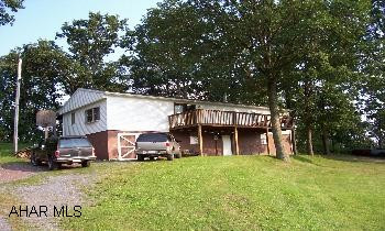 Trailer with addition on foundation and 1.5 acres. 2 miles from Lake Raystown. Newer roof, beautiful lot, very quiet. Owner will consider Article of Agreement.
