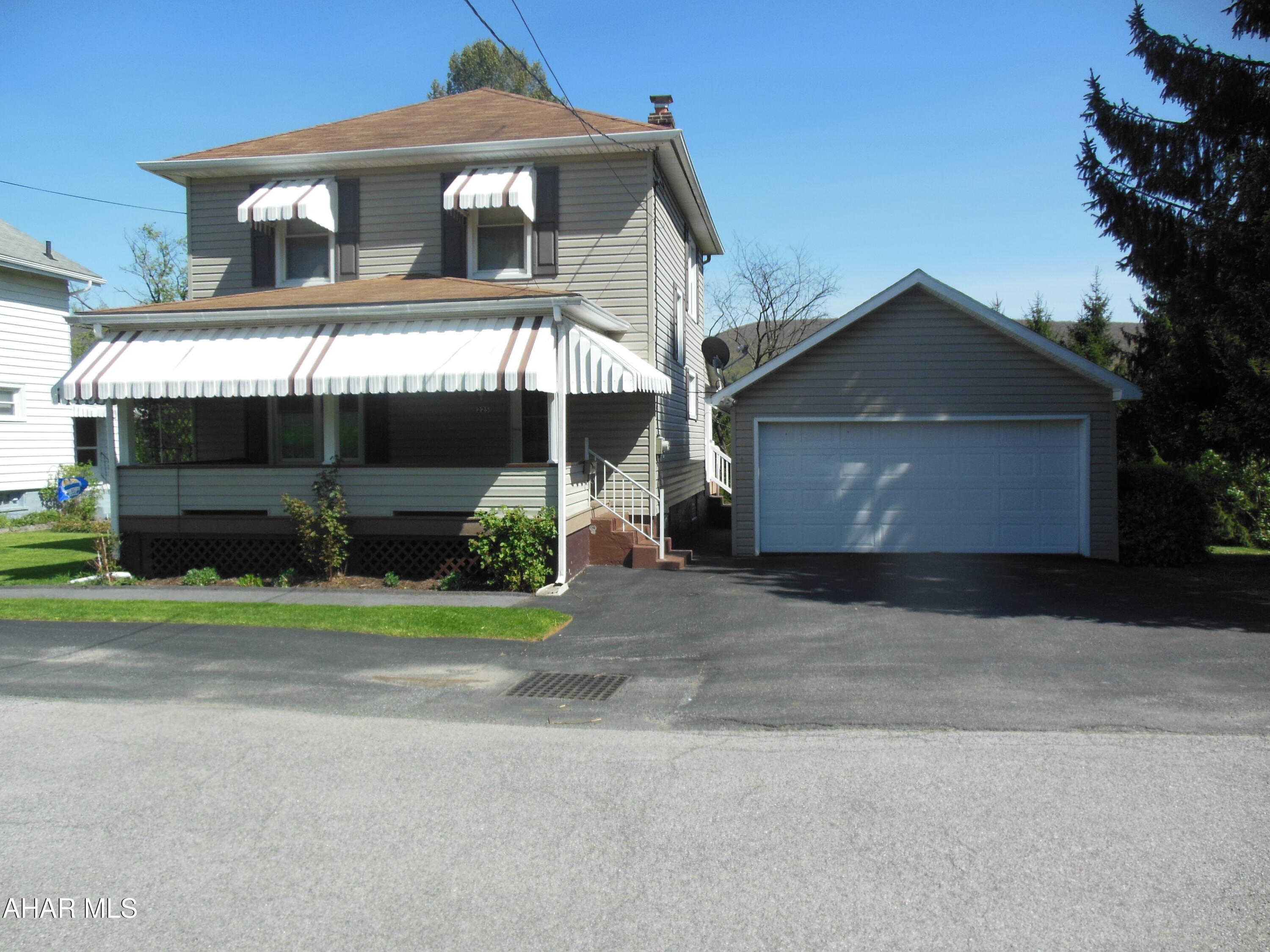 Attractive 2-Story home on a large, corner lot, with some nice updates.  Oak Kitchen with appliances. Updated HE Furnace with central air. Vinyl-sided and newer windows. Covered porches (rear is exceptional with views) off kitchen. Newer 2-car garage with opener, a shed, on a terraced lot.