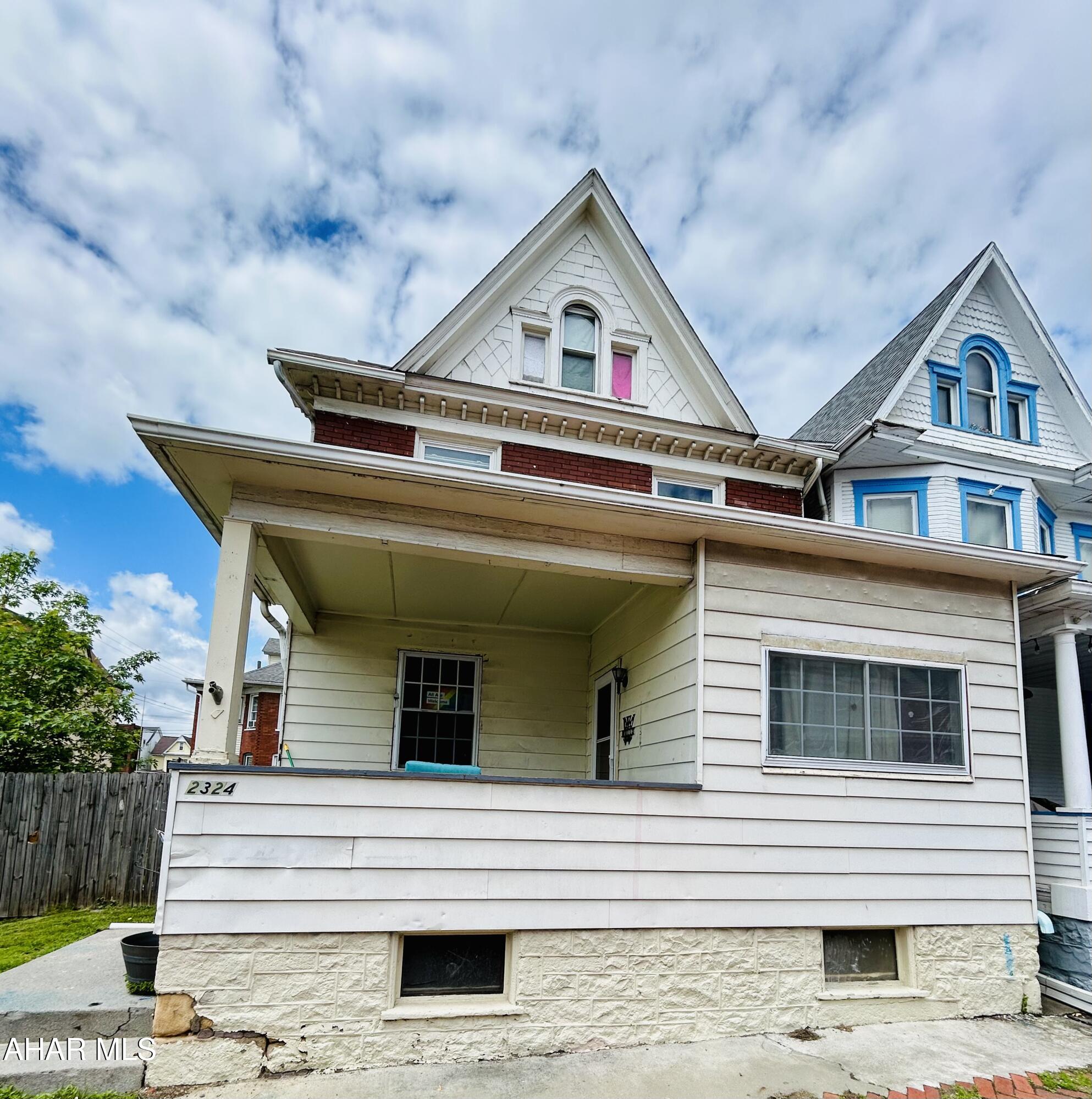This house is located on 2 parcels of land with plenty of room to update it both inside and out.  The home has 6 possible bedrooms (4 on the 2nd floor and 2 on the third floor), 2 full baths, covered closed in back porch, large fenced in yard, first floor laundry, and plenty of living space.  Put your own personal touches to bring out the beauty of the stain glass window and beautiful staircase. Currently used as an investment property with rental certificate. Tenants are long term.   Set up your showing today.