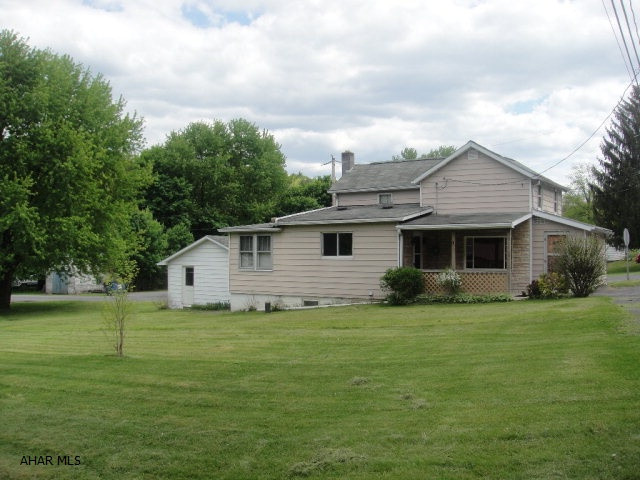 Two story home on corner lot. Two bedroom, one full bath with covered porch and a one car garage. Large, flat yard with detached garage. Oil forced air heat. Nice family home.