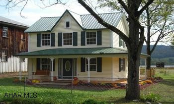 See comments. Just re-built and an addition added and a job very, very well done!  Re-built from studs - all updated electrical, wiring, siding, windows, roof.  Finished very tastefully with neutral paint choices, berber carpeting, solid oak cabinetry, stainless steel kitchen appliances convey as does the built-in microwave and dishwasher!  Second floor laundry area with stackable washer and dryer that convey!  All spacious rooms.  Main bath offers a jacuzzi tub and a shower along with double sinks.  Some vaulted ceilings, half bath on main floor, berber carpeting, ceramic flooring, kitchen has recessed lighting.  Half wrap covered porch, fenced yard, mature trees.  Stream on property. Zoned heating. Septic just pumped.  City water has no meter - bill = $40/mth. Original yr built = 1920, rebuilt this past year.
