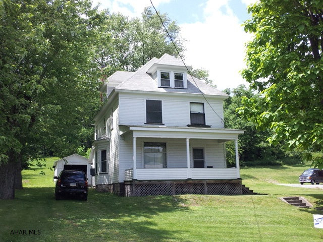 2 1/2 story, 5 bedroom home with 2 full baths on 4.58 acres. Natural woodwork. Newer furnace. 1 car garage. Very nice residential neighborhood.