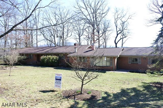Sprawling ranch home on a gorgeous, tree studded lot with a spectacular view.  Living Room has a vaulted ceiling, brick fireplace and a big picture window to bring the outdoors in. Great Room has a cozy, rustic feel with another FP.   3 BR's, 2.5 Baths, Office...and lots of space for storage.  Kitchen has an open design and an eating island...with cook top and down-draft grill. Hardwood floors, fresh, new carpet in the bedrooms.  New paint through out...move right in and enjoy the views and spacious lot....complete with patio and horse shoe pits!!!  Easy living all on one floor, attached 2 car garage.