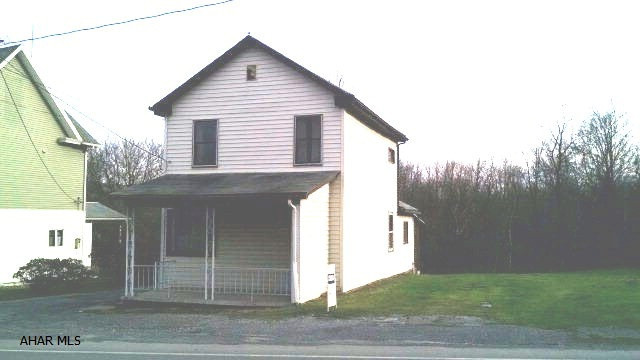 Lot, covered enclosed back porch, large living room, gas f/a, eat in kitchen. Additional building lot is available and adjoins this property for $25,000. Covered car port. Great investment opportunity.