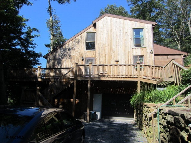 This is a beautiful cedar sided home on approx 1 1/2 acres.  There is an upper and lower deck accessible from sliding doors on both levels.  There is a den on the main floor or could be a 3rd bedroom.  Decks surround the main level and there is a covered back porch for relaxing.  The master bedroom also has a deck with sliding doors to watch the deer roam at night.  The living room is picture perfect with a loft above.  The basement is partially finished and could be a family room or a 4th bedroom.   This property is beautifully landscaped and ready to move into. This is a must see home.