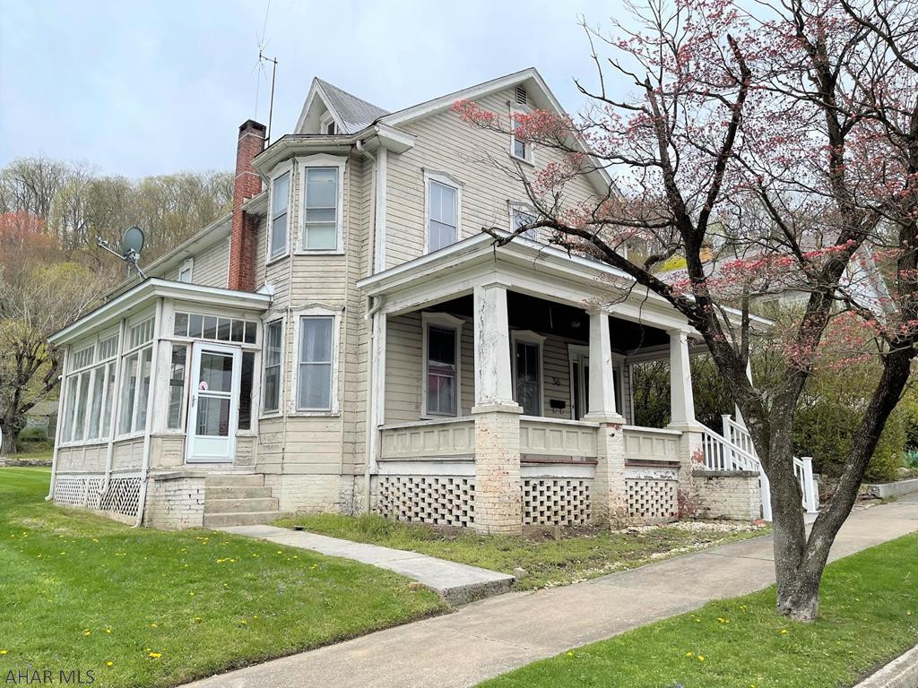 Charming two-story home with tons of character located in the Everett Borough. The main level offers a living room, dining room, den/office with built-ins, kitchen, and half bath. Side sun porch and rear enclosed porch. The second level has two bedrooms, a bonus room that can easily convert to a 3rd bedroom, and a full bathroom. Full walk-up attic that could be finished into studio or additional living space. Oil hot water heat, 100-amp electric and public water and sewer. Large rooms, an open staircase and a nice functional floor plan. Spacious yard with street to alley frontage. Detached, hand stacked stone garage and off-street parking next to it. Centrally located and convenient to all amenities. Bring your paintbrush and build instant equity!!