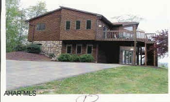 Beautiful cedar & stone contempory on 2.8 acres. Fantastic view wiht Extra Large windows & Decks overlooking Hollidaysburg area. Oak trim, central air, security system, fireplace, wet bar, 16x24 shed, realtor owned.