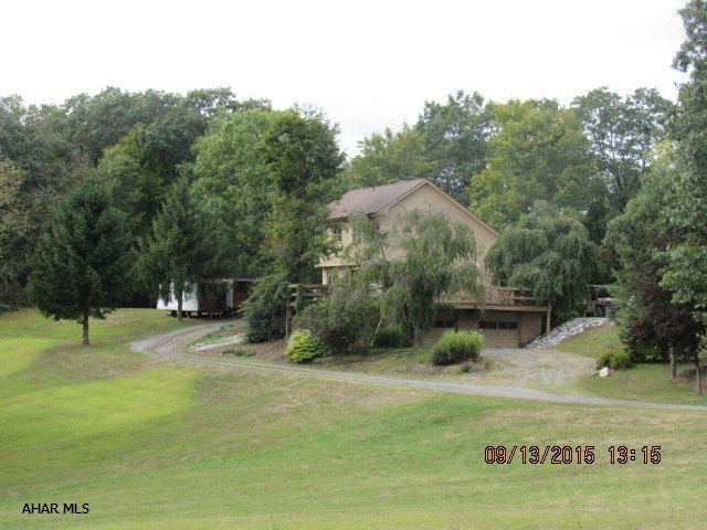 Beautiful and Unique. Great home nestled in privacy on 13.7 +/- acres. 3 Bedrooms and 4 baths. Eat-in kitchen with all the appliances and large pantry! Large living room with doors to the deck and a wood burner. Wood burner is set up to heat the entire home. Vaulted wood beamed ceilings throughout. Large master bedroom with a great master bath with jetted tub! Finished basement offers another wood burner, 3/4 bath, laundry and bar area. Huge wrap around deck for entertaining and watching the wildlife. Brand new windows throughout.