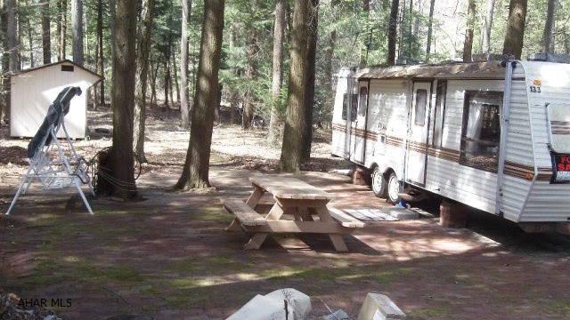 Relax and enjoy the peace on this tucked in campsite.  A brick patio and path to your shed are nice accents.  Plenty of room for your picnic and outdoor activities.  The trees surrounding you will keep you cool in the summer.  A good place to watch for wildlife.  Located in Glendale Yearound with all the amenities of the community which is adjacent to Prince Gallitzin State Park and Glendale Lake.  Only six miles from Rock Run ATV Park.  Come and see what you've been missing.