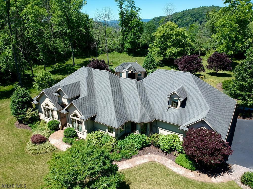 A truly unique luxury home in Hollidaysburg with so much to offer! This 4 bedroom, 3.5 bath home has over 6,000 SqFt of living space and is situated on over 4 acres of wooded ground.  The home was custom built and no expenses were spared.  There is a pool area behind the home that features a self-cleaning inground pool, hot tub, built in table/grill island, and pool house which has a sitting room, eating area and a half bath.  The property also features an incredible detached garage with a second-floor living area, plenty of workspace and enough space for 6 cars!  The entire property is professionally landscaped and hardscaped with cast lighting and an irrigation system.  There is a pavilion, perfect for large gatherings.  Be sure to check out the 3D property tour for this amazing home!