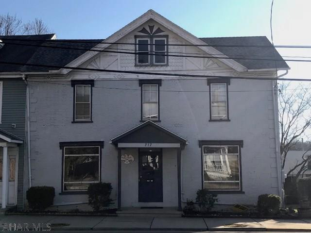 Versatile building with great exposure in town. Could be a nice size single family home or visible commercial property. Tons of parking spots in rear with a big back yard! Two entrances and separate electric for each unit. Lots of storage. Was most recently used as a multi-unit with upstairs two bedroom apartment and downstairs beauty salon. As downstairs and upstairs are not  entirely separated it would be very easily converted into a large single family home. Big rooms with income potential. Walk-up attic storage and full basement. So many options! Call for your showing today.