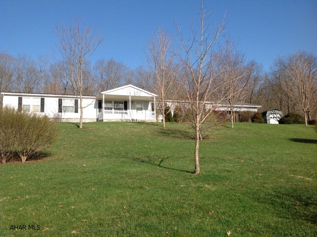 Spacious doublewide on 2.26 acres. 24x24 2 bay carport with cement floor. 14x30 shed for storage. 19x8 cement front porch and vinyl railing, 16x18 wood deck off kitchen, Large walkin closet in master bedroom with a 10x12 sitting room. Block crawlspace foundation. Bathroom with skylight.  Master bath with double sink, garden tub and seperate shower.  Nicely landscaped with privacy and beautiful view of the country!!