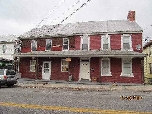 Do-It-Yourselfer's-Dream.  One side of this property is a 3 bdrm house and the other side is 3 apartments. Fix one up to live in, then fix the other 3 to rent. Good rental potential.  Lot runs to the Fort Bedford Park.