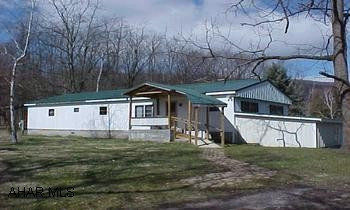Three sheds included,  Double wide (2 singles put together) on foundation and partial basement.